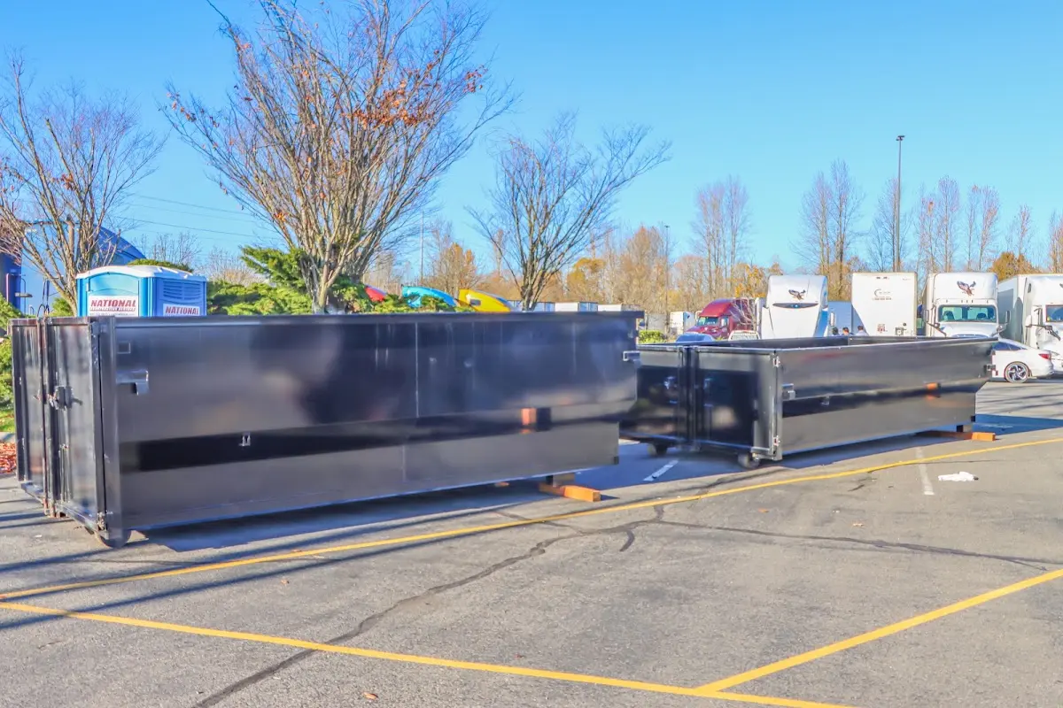 Professional dumpster rental service with roll-off container on residential driveway in Lake Park